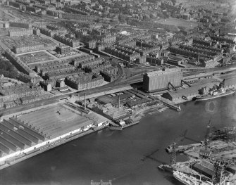 Glasgow, general view, showing Robinson Dunn and Co. Ltd. Partick Saw Mills and Meadowside Granary, Linthouse, Govan, Lanarkshire, Scotland, 1930.  Oblique aerial photograph taken facing south. Oblique aerial photograph  taken facing north-east. This image has been produced from a marked negative.