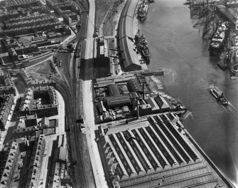 Glasgow, general view, showing Robinson Dunn and Co. Ltd. Partick Saw Mills and Meadowside Granary, Linthouse, Govan, Lanarkshire, Scotland, 1930.  Oblique aerial photograph taken facing east. Oblique aerial photograph  taken facing north. This image has been produced from a marked negative.