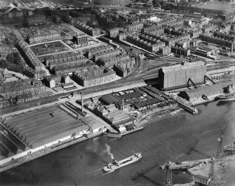 Glasgow, general view, showing Robinson Dunn and Co. Ltd. Partick Saw Mills and Meadowside Granary, Linthouse, Govan, Lanarkshire, Scotland, 1930.  Oblique aerial photograph taken facing north-east. Oblique aerial photograph  taken facing north. This image has been produced from a marked negative.