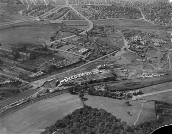 Robinson Dunn and Co. Ltd. Temple Saw Mills and High Knightswood Housing Estate, New Kilpatrick, Dunbartonshire, Scotland, 1930.  Oblique aerial photograph taken facing west. This image has been produced from a damaged negative.