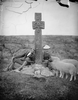 View of Keills cross with couple and sheep.