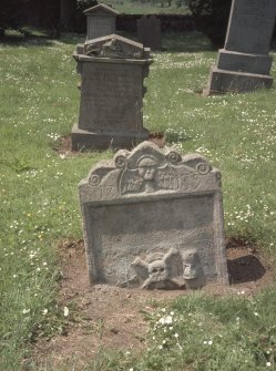 View of part buried  headstone dated 1739 showing soul, skull and bones, Newburn Old Parish Churchyard.