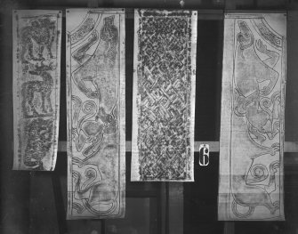 Photographic copy of four rubbings. The right and middle-left rubbings depict sections from the face of St Madoes  Pictish cross slab. The left rubbing shows the left side of the face of Dunfallandy Pictish cross slab. The middle-right rubbing is unidentified.

