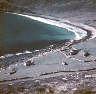 A general view of St Kilda's Village Bay, featuring the gun and magazine, the storehouse, the manse and the church and schoolroom.