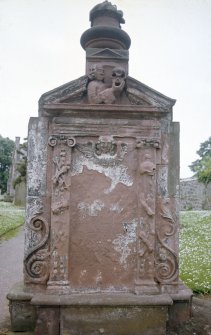 View of  headstone with decorated side panel and hand holding skull, Stenton Old Parish Church Burial Ground.