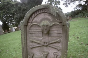 Detail of headstone 1768 showing winged soul and symbols of mortality, Whittingehame Parish Church Burial Ground.