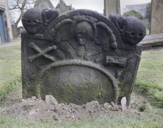 View of headstone to Margaret Shield d. 1727, with winged soul and skulls, Kirkliston Parish Churchyard.
