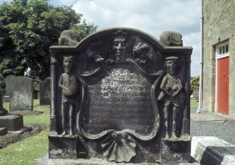 View of headstone to Thomas Graham d. 1769 with farmer and  Green Man, Livingston Parish Churchyard.