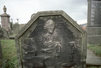 View of headstone dated 1750 and 1852 showing anvil, trumpet and hourglass, Kilsyth Burial Ground.