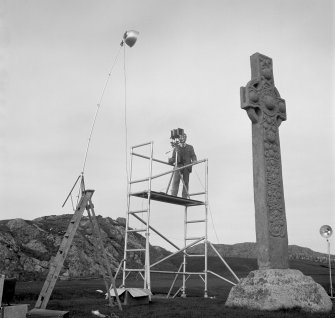 Geoffrey B Quick, RCAHMS, photographing St Martin's Cross, Iona.
