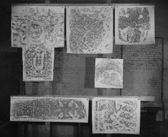 Photographic copy of six rubbings showing from top left a detail of Keills Cross, an unidentified carved stone, detail of Meigle no.3 Pictish cros slab, detail of St Vigeans no.10 cross slab, Mingaff cross slab and Drainie no.13 cross slab fragment. 

