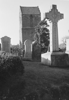 View of Stenton church tower and gravestones.