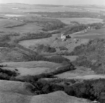 Distant oblique aerial view of Crichton Castle with Crichton Parish Church visible.