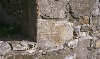 Incised cross-slab built into the frame of the east window of House 16.