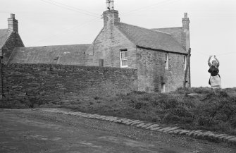 General view of Marine Inn, 40-5- Shore Street, Thurso with woman haning laundry.