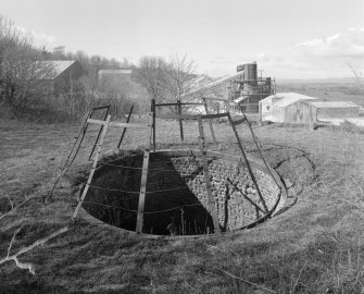 General view from ENE of lime works from top of old lime kiln, with mouth of pot in foreground