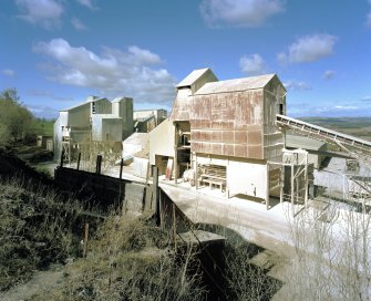 General view from SE of W end of lime works, which includes limestone milling departments containing ball mills, hopper stores, grading, bagging and conveying equipment