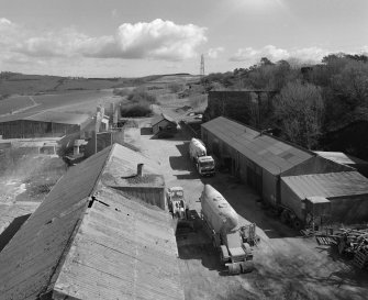 Elevated view from W (at middle level of shaft kilns) of E end of site, including workshops and offices, with old lime kiln (distant right, NO30NE 23.3)