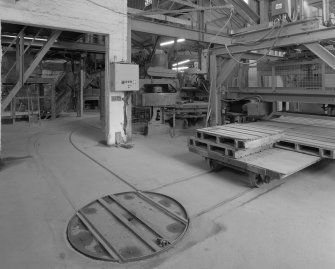 View from SE in brick pressing area, with two presses visible (centre and left), and bogie-loading machine (right), with tracks and turntable in foreground