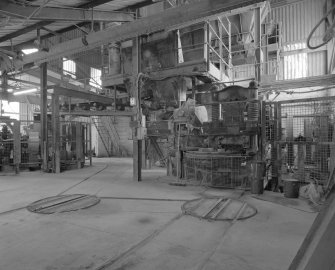 View from NW in brick pressing area, with presses (right and distant left), and bogie track and turntables in foreground