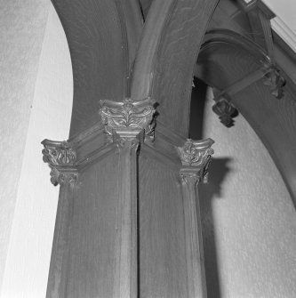 Ground floor, entrance hall,  wooden archway, carved column heads, detail