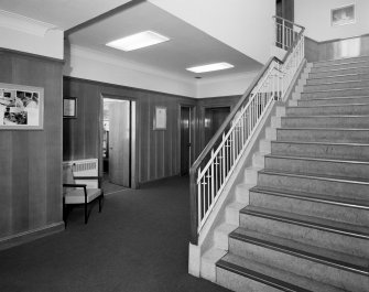 Motherwell, Craigneuk Street, Anderson Boyes
Main Offices (built 1899): Interior view from SE of main stair and wood-panelled foyer.  Beneath the carpet is a Granolite floor bearing the 'AB'  (Anderson Boyes) company logo.