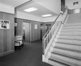 Motherwell, Craigneuk Street, Anderson Boyes
Main Offices (built 1899): Interior view from SE of main stair and wood-panelled foyer.  Beneath the carpet is a Granolite floor bearing the 'AB'  (Anderson Boyes) company logo.