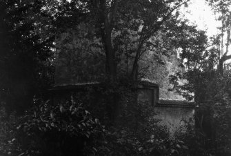 View of St Colme House dovecot, Aberdour, through trees.
