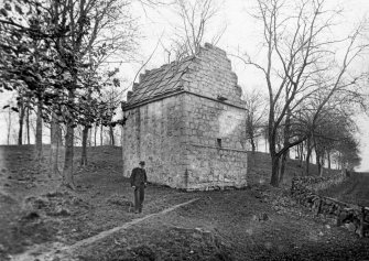 View of dovecot at Rosyth Castle from WSW with an elderly man standing beside it.