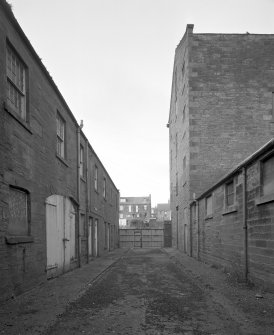View from E showing cooperage and office range, main gates, and high mill.