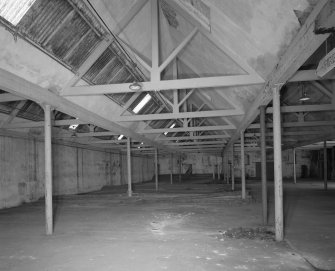 Interior view from W within single-storeyed (possibly weaving) shed to rear of high mill.