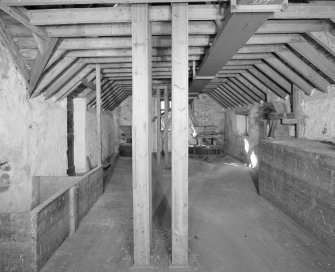 Interior.
View at upper level of mill, showing two pairs of millstones in background.