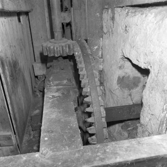 Interior.
View of ground-floor level within gear cupboard, showng water wheel axle and pit wheel (centre).