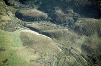 Oblique aerial view of Ewes Doors centred on the remains of a possible Roman watch tower and linear earthworks, taken from the N.