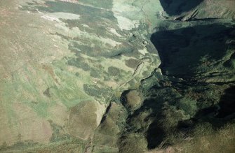 Oblique aerial view of Ewes Doors centred on the remains of a possible Roman watch tower and linear earthworks, taken from the W.