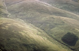 Oblique aerial view of Ewes Doors centred on the remains of hollow-ways, an old road, a possible Roman road and a linear earthwork, taken from the ENE.