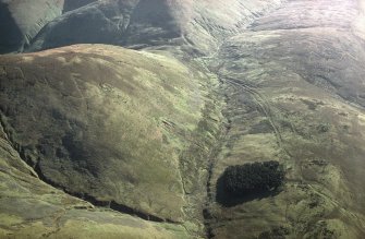 Oblique aerial view of Ewes Doors centred on the remains of hollow-ways, an old road, a possible Roman road, a linear earthwork and a possible Roman watch tower, taken from the N.