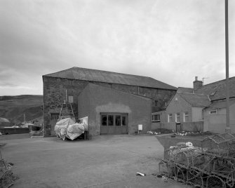 General view from E, showing the former granary block forming the E side of the building (now used as workshop and store for cabinet maker, but previously converted to ice store for white fish following erection of fish processing works on W side in 1896)