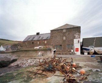 General view from S (harbour side), showing former granary (right) and fish-processing bays (left), which were added in 1896