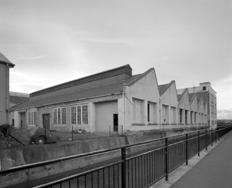 View from E of six-bay brick-built north-lit single-storeyed block to the rear of Highland House, overlooking the Town's Lade