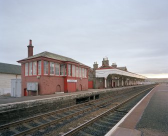 General view from N of signal box (left), station offices and south-bound platform and awning