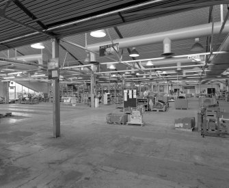 Interior view from north east in Parts Distribution Department (recently converted from Offices at south-east end of factory), occupying a former steel-framed north-lit textile mill building (originally converted circa 1957).
