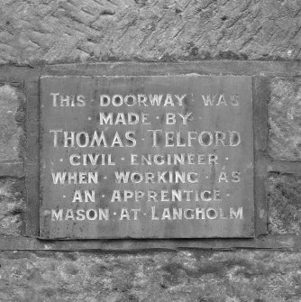 Detail of inscription on gateway; "THIS DOORWAY WAS MADE BY THOMAS TELFORD CIVIL ENGINEER WHEN WORKING AS AN APPRENTICE MASON AT LANGHOLM"
