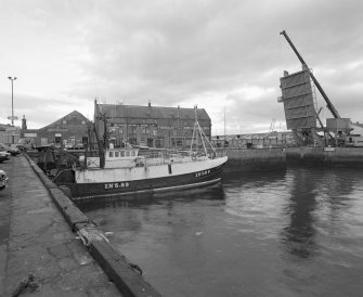 General view of South-West side of warehouse from South-West, across South Harbour.