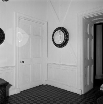 Ground floor, entrance hall, doors, dado, wooden battens and circular mirror, detail