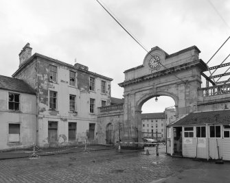 View of courtyard buildings and 'clock' entrance arch from NW