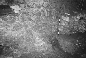 Excavation photograph : area A - light coloured mortar spreading over fragment of footing 14 and bedrock, sealed by walls 12 and 13.