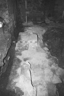 Excavation photograph : area A - looking along full length of barbican wall 4 to E wall of tower.