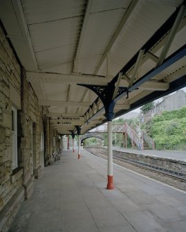 Burntisland, Forth Place, Burntisland Station
Detailed view beneath canopy of S platform, showing rubble facade of offices, and cast-iron columns and fabricated steel girders supporting canopy
