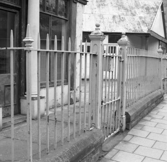 View of wrought iron railings outside showroom.